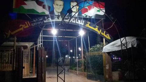 The Assads' pictures at the entrance to a children's playground  in Douma 